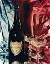 (MOËT ET CHANDON) A pair of opulent still lifes featuring the luxurious Champagne brand, including a bottle of Dom Pérignon, along with